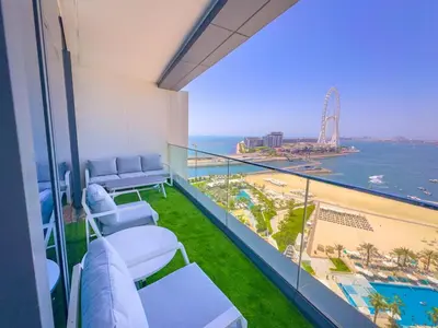 a balcony with chairs and a view of the ocean at ADDRESS BEACH RESORT Residence Million Dollar Sea and Palm View DXB AIRPORT VIP Shuttle option in Dubai