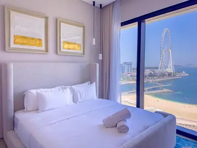 a bedroom with a large white bed with a large window at ADDRESS BEACH RESORT Residence Million Dollar Sea and Palm View DXB AIRPORT VIP Shuttle option in Dubai