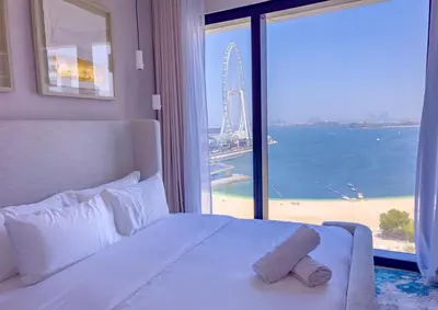 a bedroom with a white bed and a large window at ADDRESS BEACH RESORT Residence Million Dollar Sea and Palm View DXB AIRPORT VIP Shuttle option in Dubai