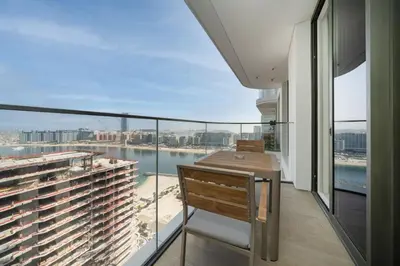 a balcony with a view of the water at Brand New Stylish 1-Bed Getaway with Private Beach and Palm Views in Dubai