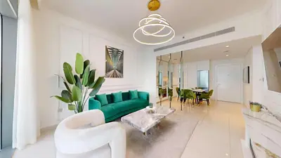 a living room with a green couch and a table at Vacationer I Luxurious 1 Bedroom Apartment I Private Beach and Infinity Pool Access in Dubai
