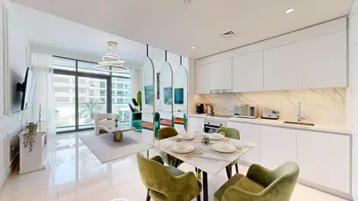 a kitchen and dining room with a table and chairs at Vacationer I Luxurious 1 Bedroom Apartment I Private Beach and Infinity Pool Access in Dubai