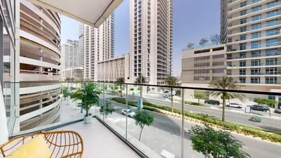 a balcony with a view of a city with tall buildings at Vacationer I Luxurious 1 Bedroom Apartment I Private Beach and Infinity Pool Access in Dubai