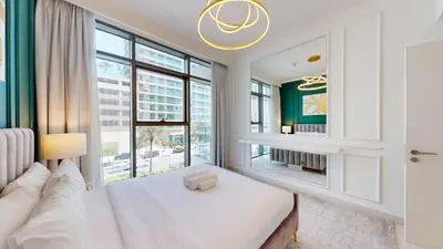 a bedroom with a bed and a large window at Vacationer I Luxurious 1 Bedroom Apartment I Private Beach and Infinity Pool Access in Dubai