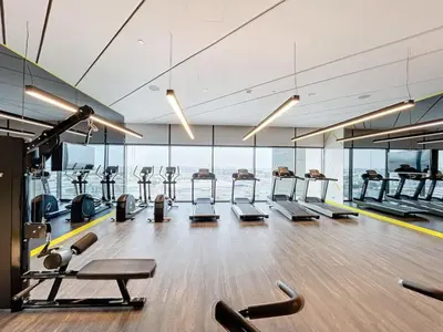 a gym with a row of treadmills and machines at Vacationer I Luxury 2 Bedroom Apartment I Business Bay, Near Dubai Canal I Aykon City Tower 2 in Dubai