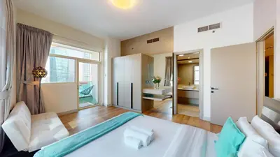a bedroom with a white bed and a large window at Vacationer I Steps to Metro I Premium 2 Bedroom Apartment I Yacht Bay Marina in Dubai
