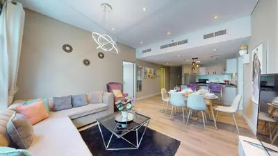a living room with a couch and a table at Vacationer I Steps to Metro I Premium 2 Bedroom Apartment I Yacht Bay Marina in Dubai