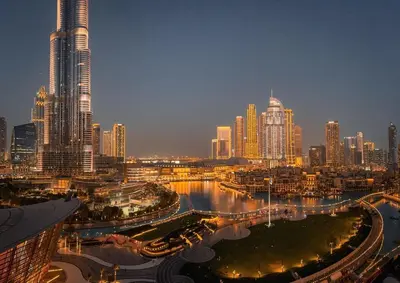 a view of a city at night with tall buildings at GRANDE SIGNATURE with a direct Burj Khalifa view and Private Fountain Show with DXB AIRPORT VIP Shuttle option for 6 guests in Dubai
