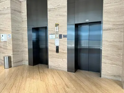 two elevators in a lobby of an office building at Brand New , Skyline View in Dubai