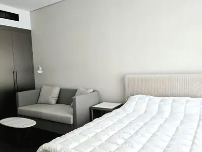 a bedroom with a bed and a couch at Brand New , Skyline View in Dubai
