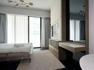 a bedroom with a bed and a sink and a mirror at Brand New , Skyline View in Dubai