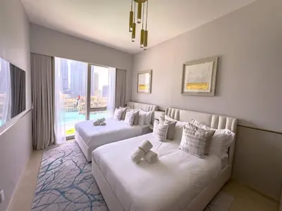 a hotel room with two beds and a large window at GRANDE SIGNATURE with a direct Burj Khalifa view and Private Fountain Show at high floor with DXB AIRPORT VIP Shuttle option for 8 guests in Dubai