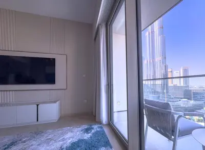 a living room with a tv and a large window at GRANDE SIGNATURE with a direct Burj Khalifa view and Private Fountain Show at high floor with DXB AIRPORT VIP Shuttle option for 8 guests in Dubai
