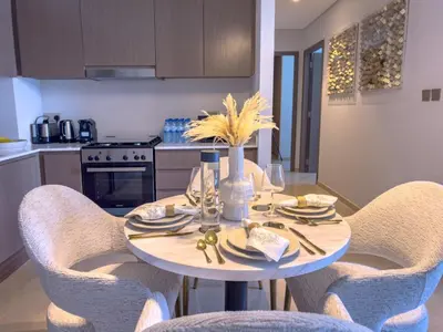 a kitchen with a table with chairs and a dining room at GRANDE SIGNATURE with a direct Burj Khalifa view and Private Fountain Show at high floor with DXB AIRPORT VIP Shuttle option for 8 guests in Dubai