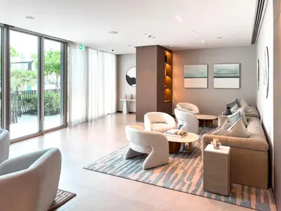 a living room with a couch and chairs and tables at GRANDE SIGNATURE with a direct Burj Khalifa view and Private Fountain Show at high floor with DXB AIRPORT VIP Shuttle option for 8 guests in Dubai