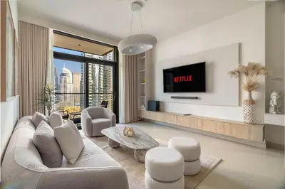 a living room with a couch and a tv at Luxurious 4BR with Boulevard View - 10 min to Burj & Mall in Dubai