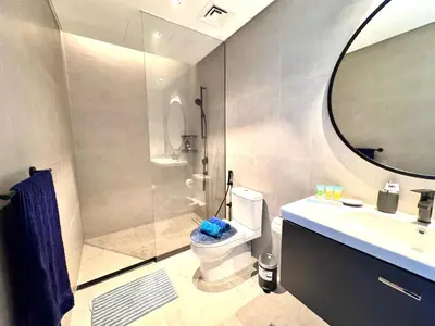 a bathroom with a shower and a toilet and a sink at Luxury Apartment Burj Khalifa View Summer Offer in Dubai