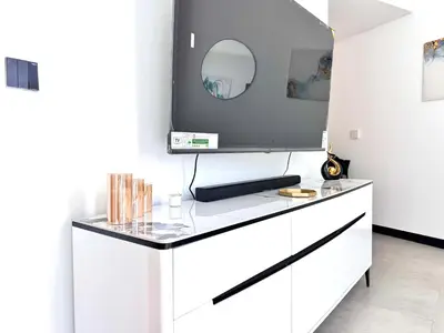 a white dresser with a tv on top of it at Luxury Apartment Burj Khalifa View Summer Offer in Dubai