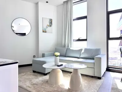 a living room with a couch and a table at Luxury Apartment Burj Khalifa View Summer Offer in Dubai