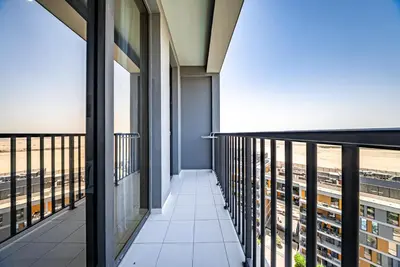 a corridor in a building with views of the city at Studio in Dubai Production City in Dubai