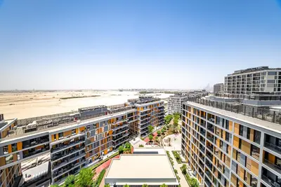 an aerial view of apartment buildings and the beach at Studio in Dubai Production City in Dubai
