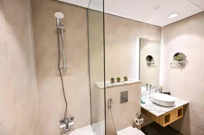 a bathroom with a shower and a sink at Amazing 2 Bed Burj views in Dubai