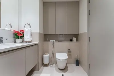 a white bathroom with a toilet and a sink at Creek palace residence by Hogar in Sabkhah