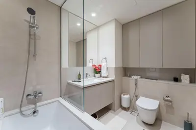a bathroom with a shower and a toilet and a sink at Creek palace residence by Hogar in Sabkhah