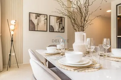 a dining room with a table with a vase at 2BR with Marina View, Walking Distance to Marina Mall, Metro Station & JBR Beach, Al Majara 1, Dubai Marina by Deluxe Holiday Homes in Dubai