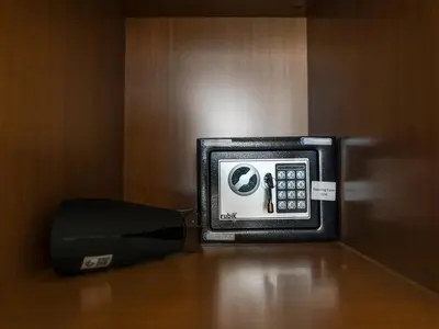 a phone sitting on top of a table next to a telephone at Premium Studio Private Jacuzzi Canal View in Dubai