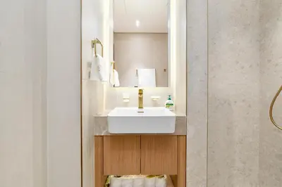 a bathroom with a white sink and a mirror at Ahlan HH - Brand New Summer Suite, Near Circle Mall in Dubai