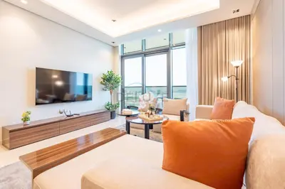 a living room with a couch and a tv at Skyline View 1BR, Minutes Away from Downtown and Dubai Mall, Nobles Tower, Business Bay by Deluxe Holiday Homes in Dubai