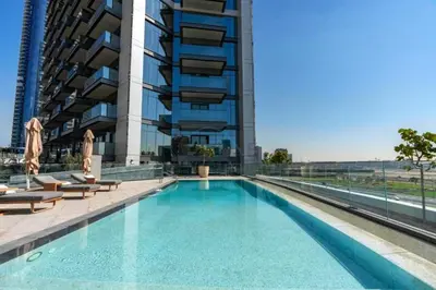 a swimming pool in front of a tall building at Skyline View 1BR, Minutes Away from Downtown and Dubai Mall, Nobles Tower, Business Bay by Deluxe Holiday Homes in Dubai