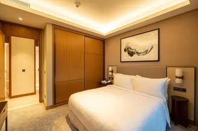 a bedroom with a large white bed in a room at Venetian - Signature 3BR with Burj Khalifa & Fountain views in Dubai