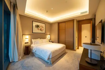a hotel room with a bed and a sink at Venetian - Signature 3BR with Burj Khalifa & Fountain views in Dubai