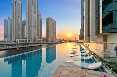 a swimming pool in a city with tall buildings at Modern apartment in a prime location in Dubai! in Dubai