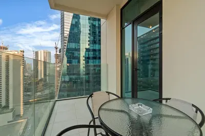 a table on a balcony with a view of a city at Modern apartment in a prime location in Dubai! in Dubai