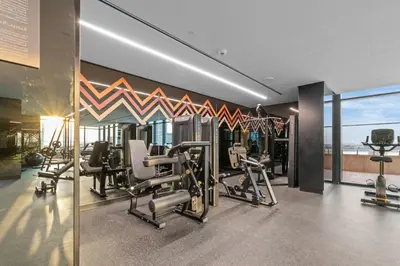 a gym with cardio equipment in a building at Modern apartment in a prime location in Dubai! in Dubai