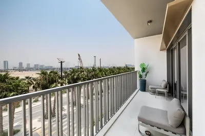 a balcony with a chair and a view of the desert at ALiving Modern & Chic 1BR I MAG960 in Dubai