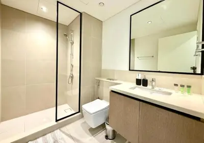 a bathroom with a shower and a toilet and a sink at Luxurious and Spacious 2BR Burj Crown Downtown in Dubai