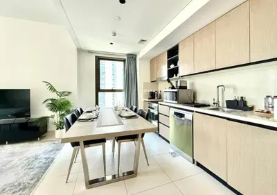 a kitchen with a wooden table in a room at Luxurious and Spacious 2BR Burj Crown Downtown in Dubai
