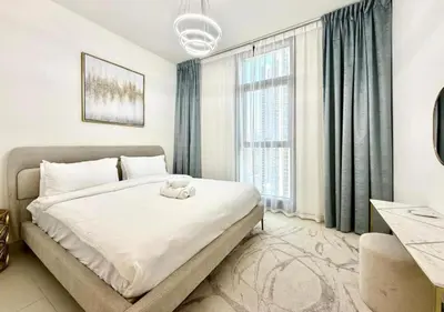 a bedroom with a bed and a large window at Luxurious and Spacious 2BR Burj Crown Downtown in Dubai