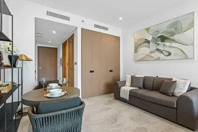 a living room with a couch and a table at Designer Studio w Burj Khalifa view in Peninsula in Dubai