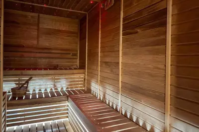 a wooden sauna with a bucket in the middle at Designer Studio w Burj Khalifa view in Peninsula in Dubai