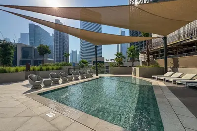 a swimming pool on the roof of a building at Designer Studio w Burj Khalifa view in Peninsula in Dubai