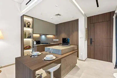 a kitchen with a wooden counter and a sink at Chic Retreat 1Bedroom with Pool view in Dubai