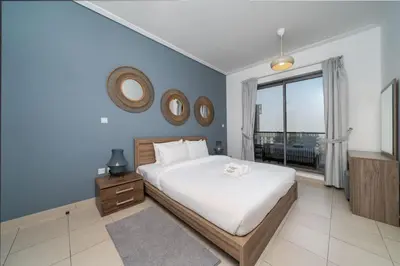a bedroom with a bed and a large window at Downtown Luxury 1 Bed with City Skyline Views in Dubai