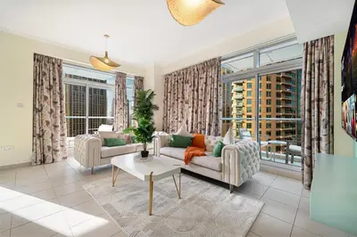 a living room with a couch and a table at Serene Cozy 2BR Near Burj Khalifa in Dubai