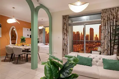 a living room with a couch and a table and a window at Serene Cozy 2BR Near Burj Khalifa in Dubai