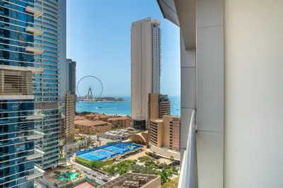 a view of the city from the balcony of a skyscraper at Cityscape & Coastal Charm Elegant 2BR Seaside in Dubai Marina